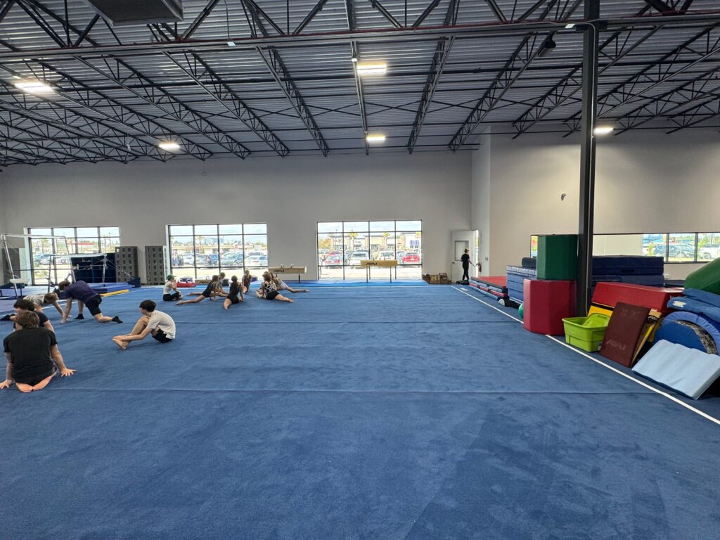 Gymnasts start their first warmup in Thornton's Gymnastics Center new location